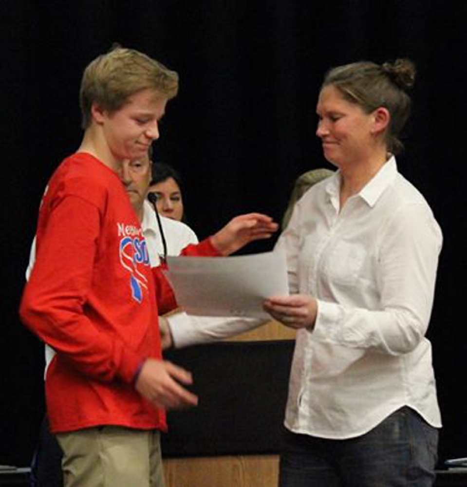 Colby Charette, left, accepts the Kennebec Valley Athletic Conference Class A Girls Soccer Player of the Year award on behalf of his late sister, Cassidy, from Messalonskee coach Penny Stansfield at an awards banquet Thursday night. Cassidy Charette died in a hayride accident last month. She was 17.