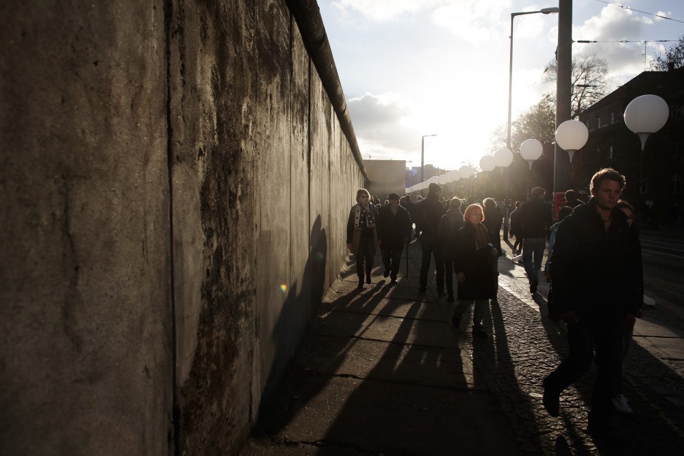 Spectators walk between balloons of the art project ‘Lichtgrenze 2014’ and remains of the former Berlin Wall at the wall memorial Bernauer Strasse in Berlin, Germany, on Saturday. The light installation featuring 8,000 luminous white balloons commemorates the division of Berlin where the 25th anniversary of the fall of the wall is marked with numerous events on the weekend.