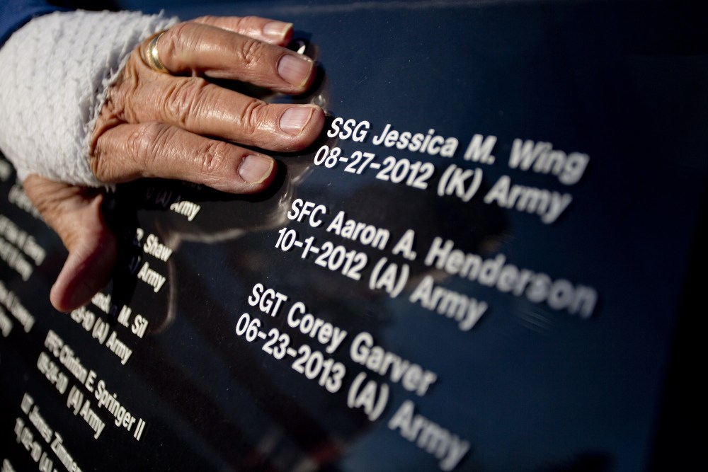 Larry Dearborn of Richmond on Saturday moves his hand over the lettering on the window of his 1997 Lincoln Town Car Limousine that he and his wife Rita drive around the state to honor veterans of America’s wars. Dearborn has every Maine soldier who has died in battle since 9/11 listed on the windows of his car. The Dearborns plan to take part in this year’s parade in Richmond.