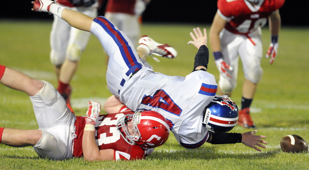 Messalonskee running back Caleb Chavarie is hauled down by Cony linebacker Reid Shostak in a game earlier in the season. Cony was knocked out of the playoffs last Saturday by Lawrence.