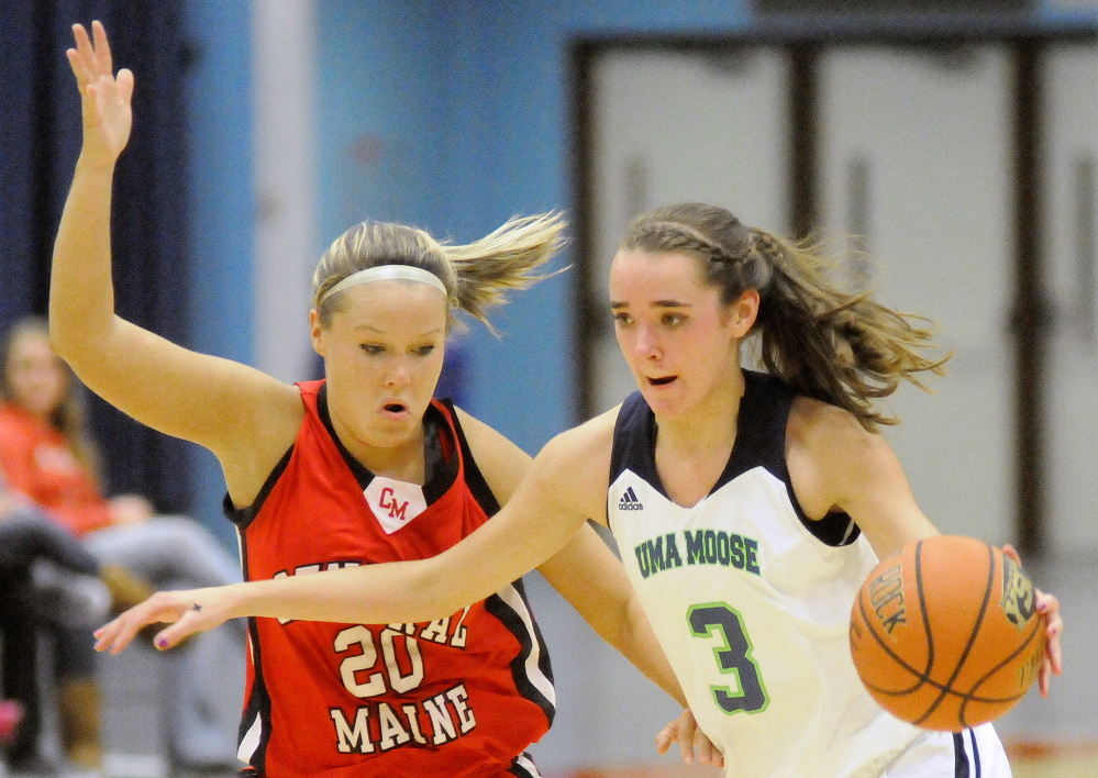 Staff photo by Andy Molloy 
 University of Maine at Augusta forward Jamie Plummer, right, dribbles around Central Maine Community College's Corrina Kinder during a game Wednesday at the Augusta Civic Center.