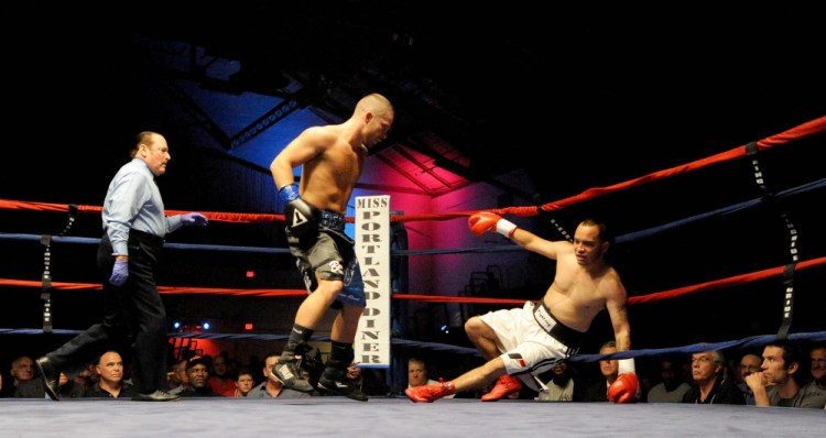 Staff photo by Michael G. Seamans 
 Brandon "The Cannon" Berry knocks down Moises Rivera in the 4th round of a June 14 bout at the Portland Expo. Berry defeated Rivera in 4 rounds by TKO.