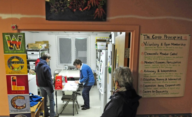 Betty Morrell, online marketplace manager of the Kennebec Local Food Initiative Online Buying Club, center, helps customers pick up their orders at Faith Christian Church in Gardiner earlier in November.