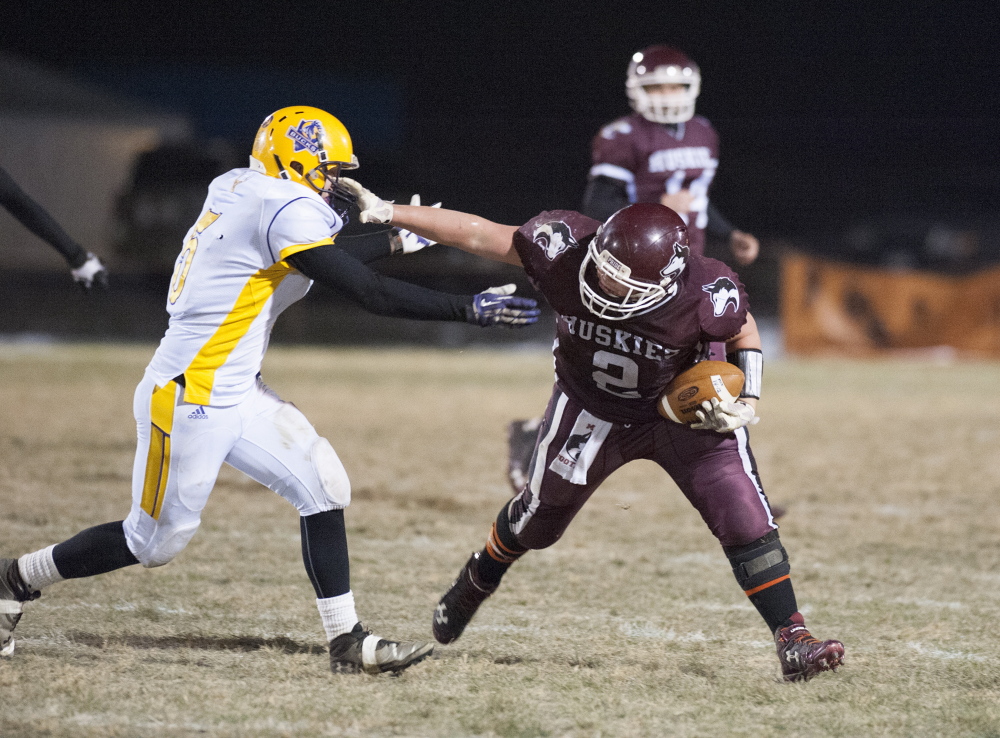 Kevin Bennett photo 
 Maine Central Institute running back Alex Bertrand shakes off a tackle by Bucksport’s Chase Carmichael during the Little Ten Conference title game Saturday night.