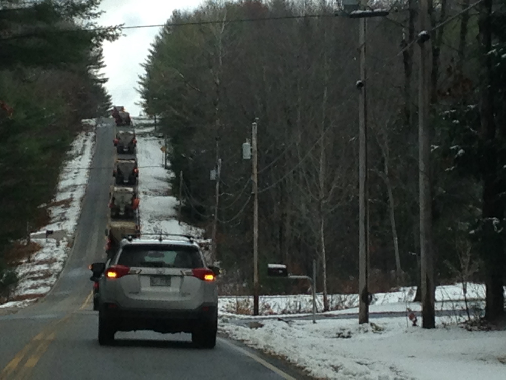 Monmouth Public Works employees escort Herb Whittier home from work for the final time Friday with a parade of plow trucks. Whittier retired 45 years after he first went to work for the town.