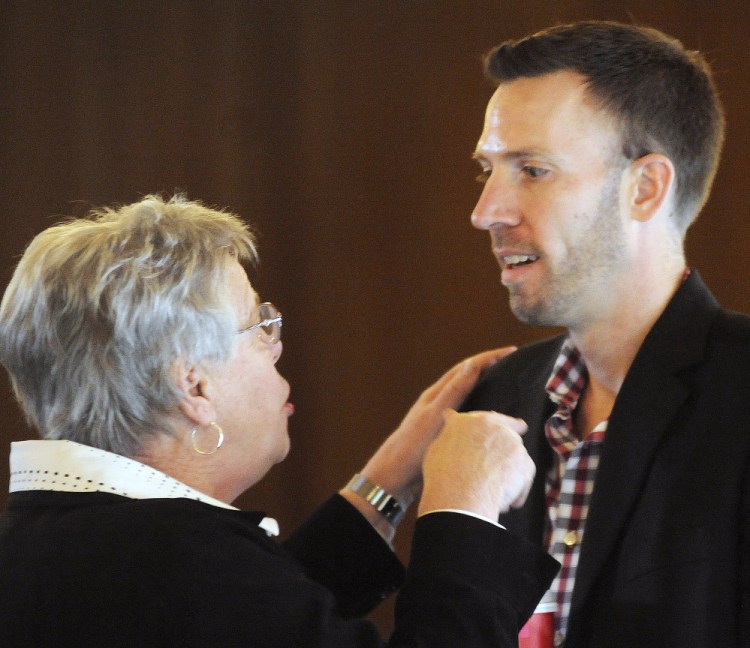 Phil Bartlett, of Gorham, speaks with Maine Democratic Party Vice-Chairwoman Pam Fenrich during a meeting in Augusta on Sunday to elect a new chairman of the party. Bartlett, of Gorham, won the position by a large margin.
