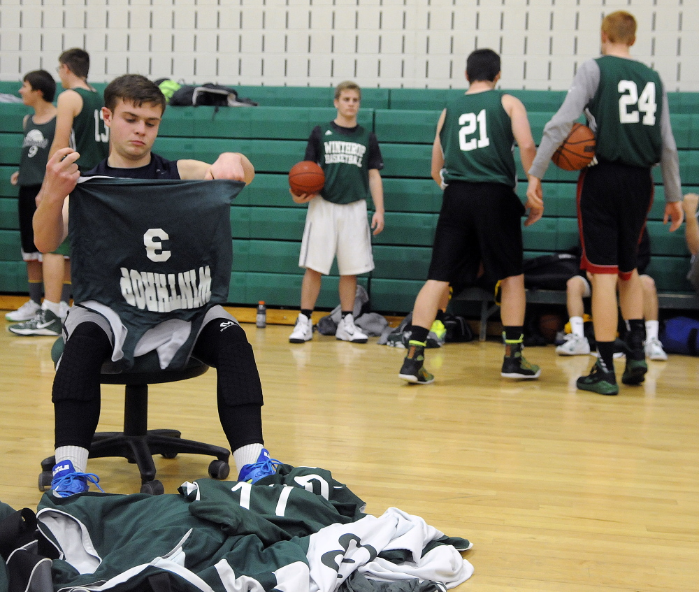 Staff photo by Andy Molloy 
 Winthrop sophomore Caleb Fortin finds a jersey Monday afternoon before the first practice of the season.