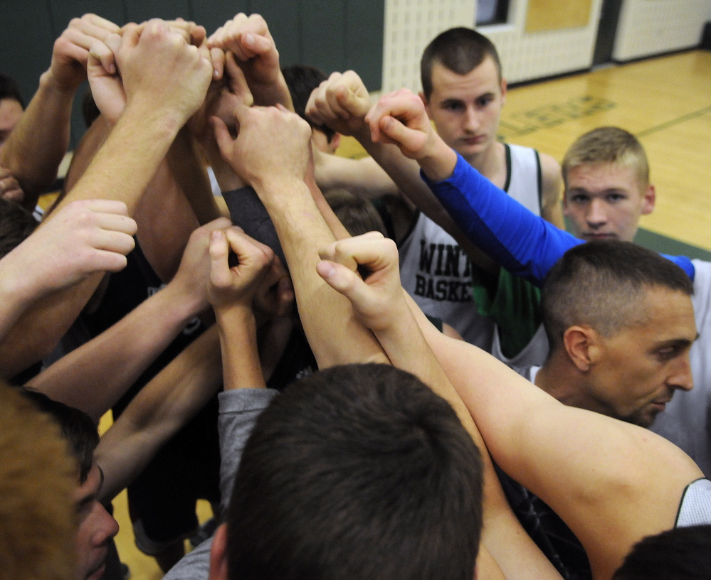 Staff photo by Andy Molloy 
 Members of the Winthrop boys basketball team gather with head coach Todd MacArthur on Monday before the first basketball practice of the season.