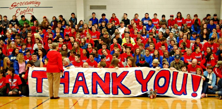 Messalonskee High School Assistant Principal Paula Callan organizes students for a photographic thank you to the many communities across the state that provided support to the school in the wake of the deaths of two students. More than 700 students and staff turned out.