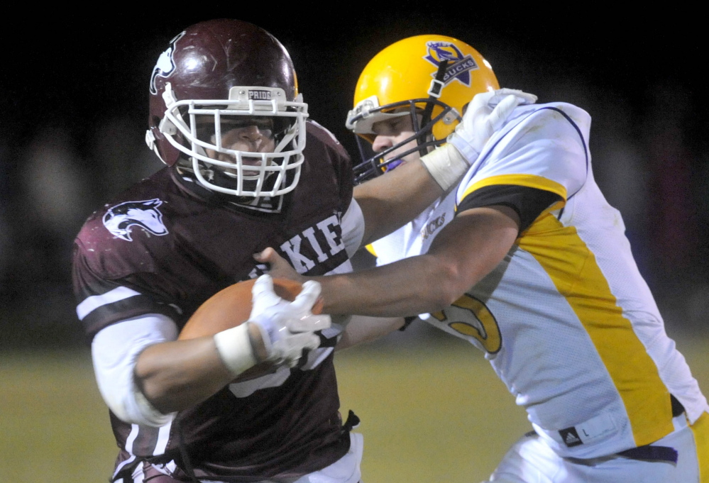 Maine Central Institute’s Eric Hathaway, left, has contributed both as a running back on offense and as a nose guard on defense this season. The Huskies play Oak Hill for the Class D state championship on Saturday in Portland.