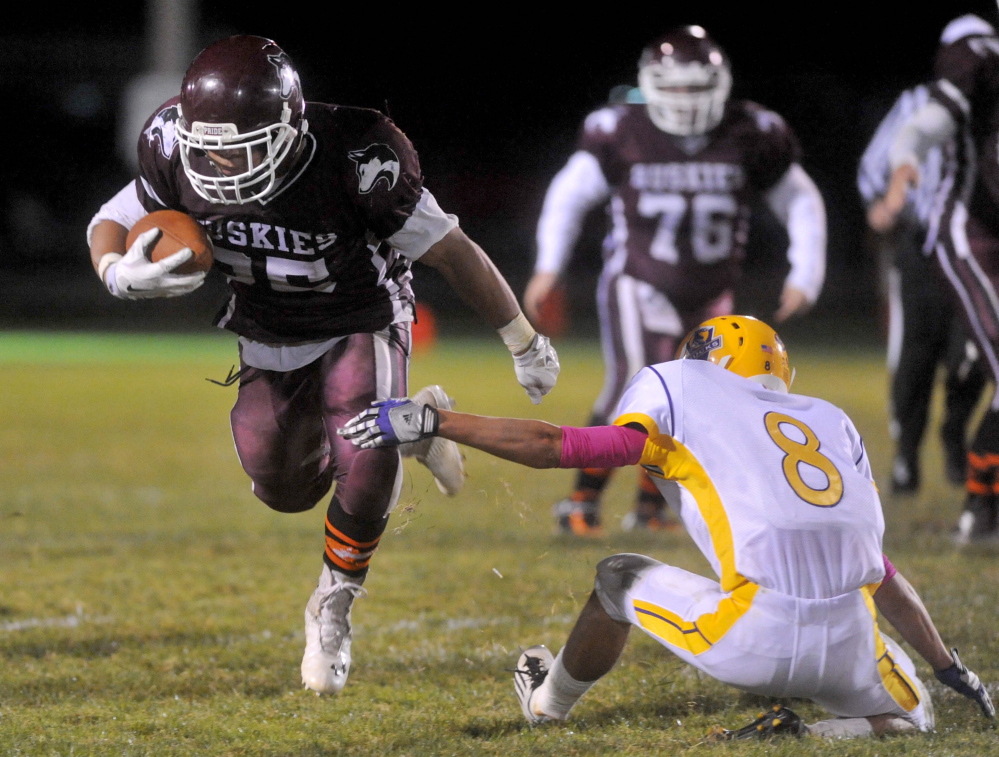 Maine Central Institute’s Eric Hathaway, left, breaks a tackle during a game against Bucksport earlier this season. MCI play Oak Hill for the Class D state championship on Saturday.