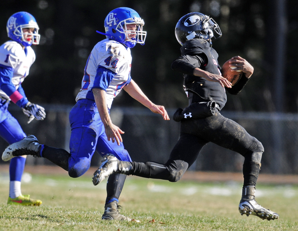 Oak Hill defensive end Kyle Flaherty chases down Lisbon wide receiver Tyler Halls during the Western Class D championship game on Saturday in Lisbon. The Raiders play MCI on Saturday for the Class D state championship at Fitzpatrick Stadium in Portland.