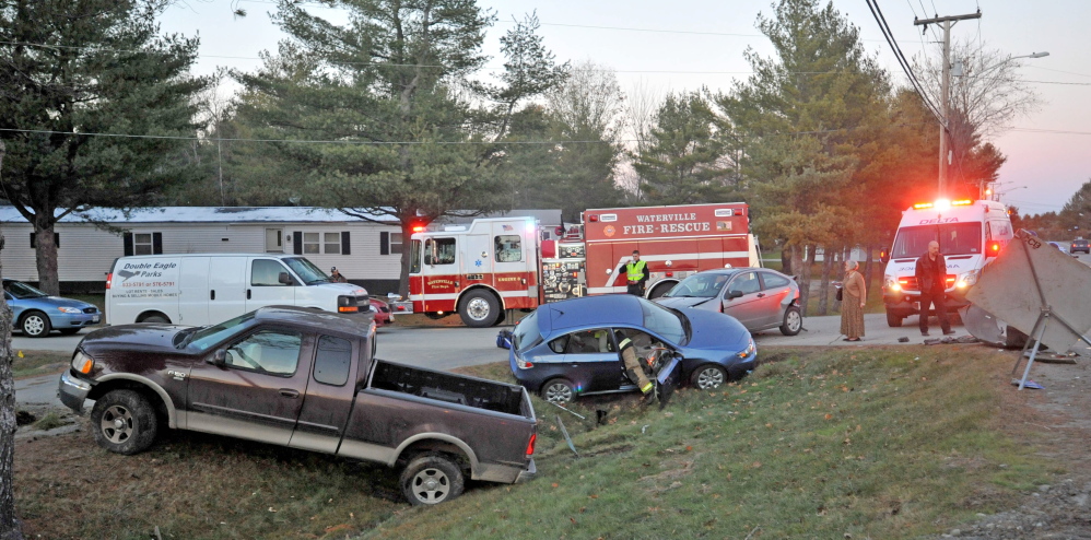 Firefighters from Waterville fire department, paramedics from Delta Ambulance and Waterville police respond to the scene of a three-car accident at Jacobs Drive and West River Road on Wednesday.
