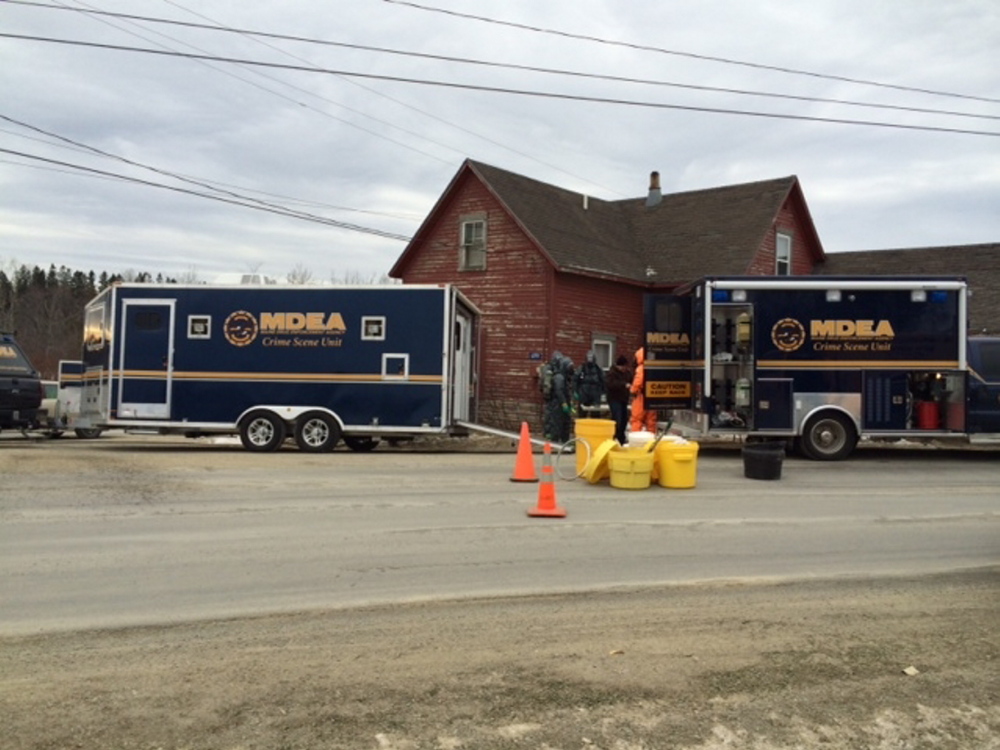 Drug agents go into the home on 699 Walker Road on Saturday in Hodgdon. James Boyce, 31, was arrested following a search at the home and charged with trafficking in methamphetamine.