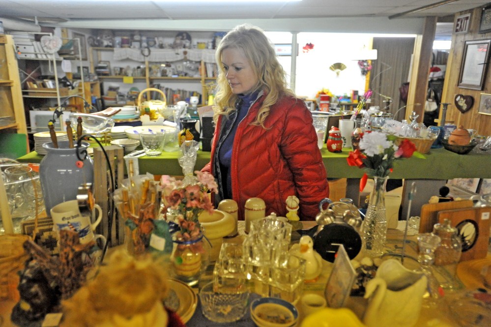 WATERVILLE, MAINE - NOVEMBER 21, 2014. 
 Susan Roy, executive director of Hospice Volunteers of Waterville Area, organizes donated merchandise to the resale shop at Hospice Volunteers of Waterville Area on Friday, Nov. 21, 2014.  (Staff photo by Michael G. Seamans)
