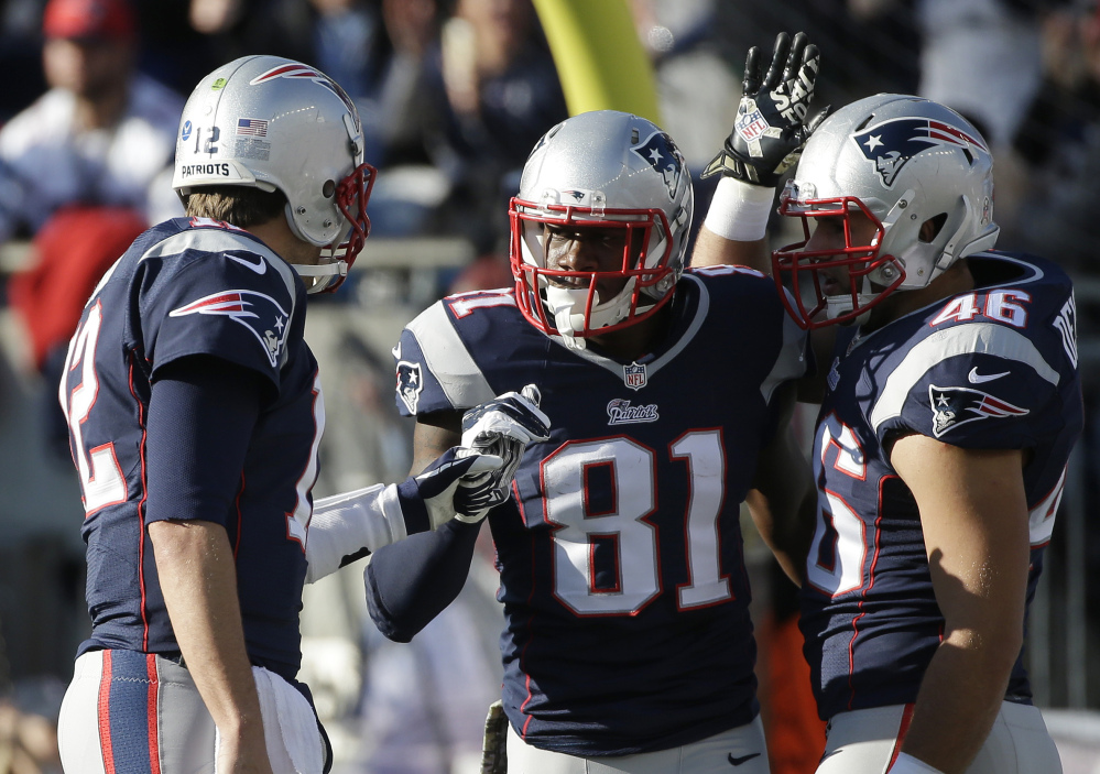 New England Patriots quarterback Tom Brady, left, celebrates his touchdown pass to New England Patriots tight end Timothy Wright (81) in the first half Sunday against the Detroit Lions in Foxborough, Mass. The Patriots won 34-9.