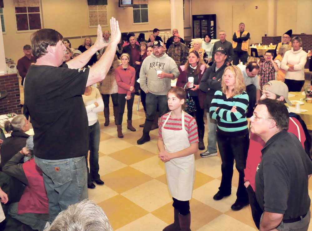 Longtime volunteer Mike Perkins organizes other volunteers Thursday before filling boxes with Thanksgiving meals to be offered to 1,000 area residents during the annual Thanksgiving dinner at Messalonskee High School in Oakland.