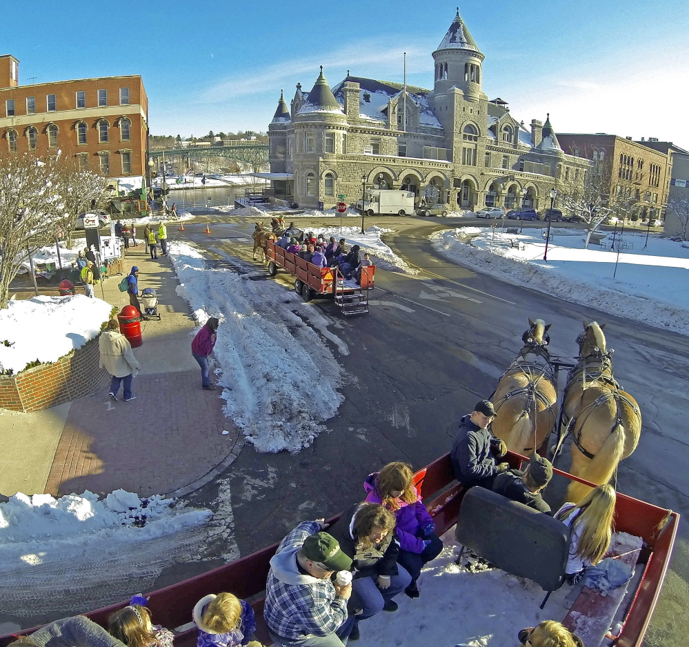 Two horse-drawn wagons give rides around downtown Saturday in Augusta. The wagons were drawn by Belgian horses from J&K Farm in Palermo.
