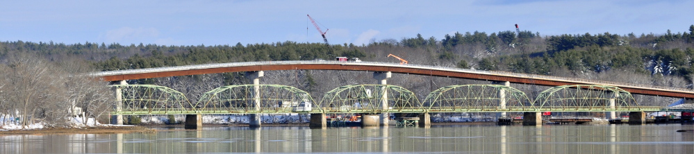 The old green metal bridge spanning the Kennebec River between Richmond and Dresden will be replaced by the new taller bridge with concrete supports following a Friday ceremony.