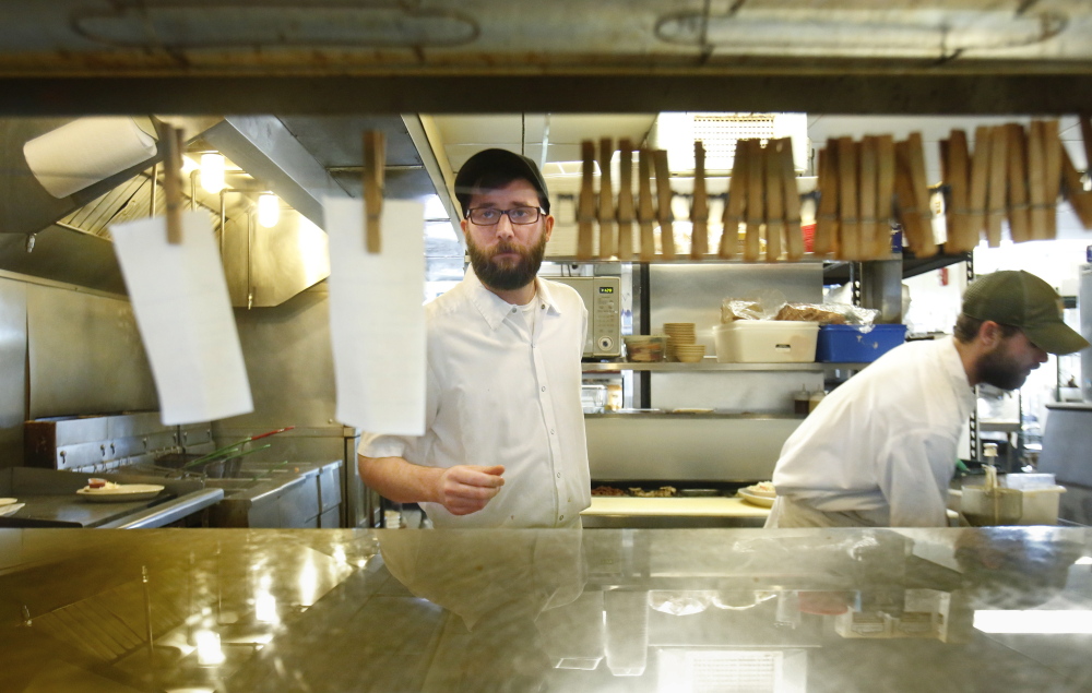 Mike Sajecki, 27, a cook at Becky’s Diner in Portland, has health insurance this year because he obtained coverage during the first round of sign-ups. His insurance costs $230 per month and includes dental and vision. “I can afford that,” he said. Gregory Rec/Staff Photographer