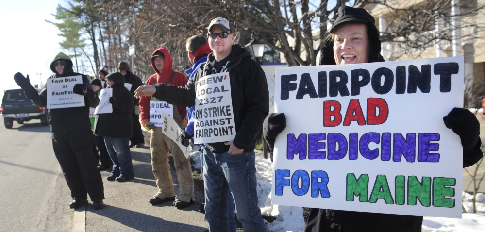 Krista MacKay of South Gardiner, right, holds a sign while picketing Tuesday outside a health care conference in Augusta sponsored in part by FairPoint Communications. Union workers across New England went on strike against the telecommunications firm on October 17 after the company imposed higher health insurance premiums, according to a release from the International Brotherhood of Electrical Workers, which represents many of the FairPoint employees.