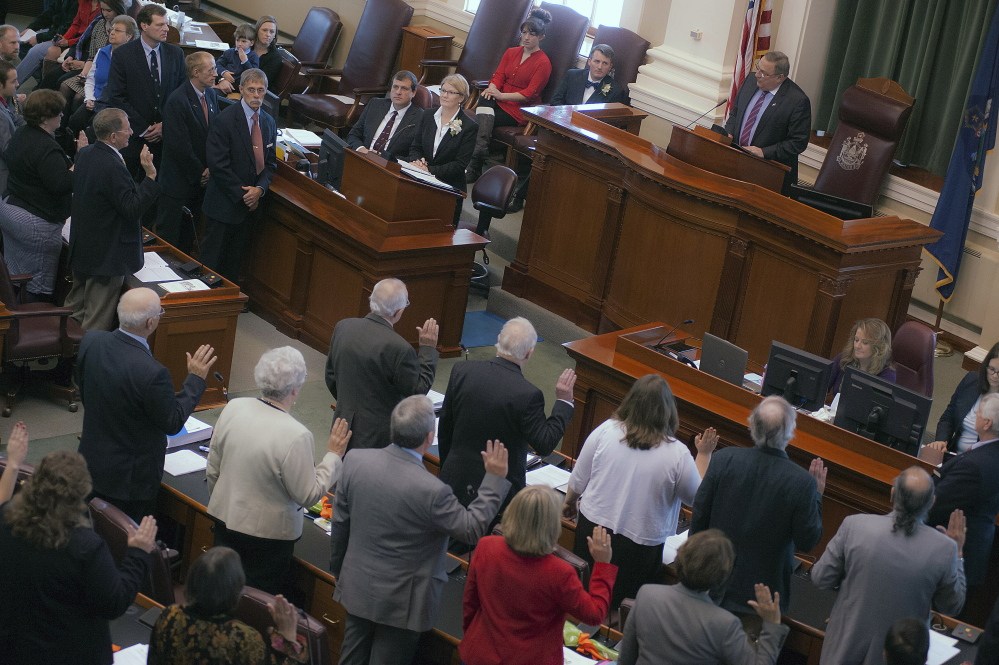 Maine Gov. Paul LePage administers the oath of office to newly elected legislators during Wednesday’s swearing-in ceremony watched by family and friends at the State House in Augusta. Republicans now hold the majority in the Senate, but Democrats remain in control of the House. Democratic Rep. Mark Eves was re-elected speaker of the House, and Republican Mike Thibodeau was elected president of the Senate.