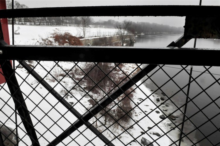 This view upstream along the west bank of the Kennebec River from the Two Cent Bridge in Waterville shows the site where city officials hope a 950-foot boardwalk can be built.