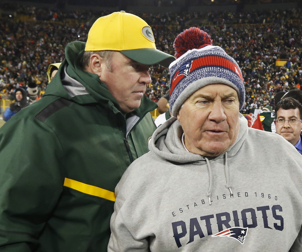 Green Bay Packers head coach Mike McCarthy talks to New England Patriots head coach Bill Belichick after Sunday’s game in in Green Bay, Wis. Belichick won’t need a winter hat this week, as the Patriots play the San Diego Chargers.