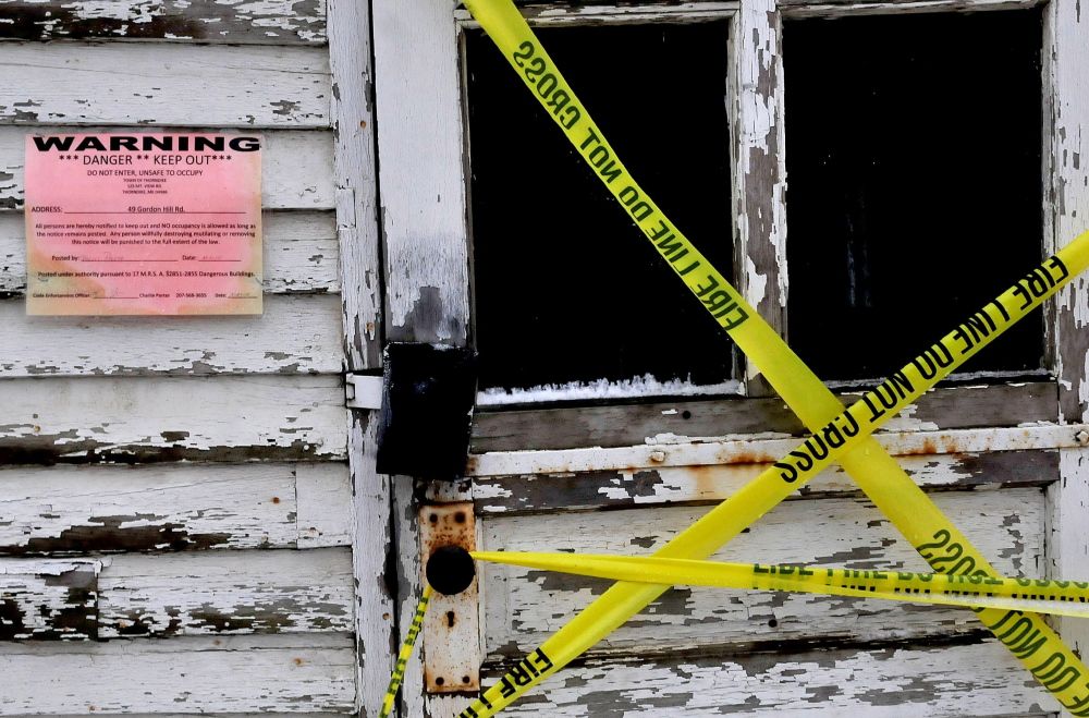 A taped off entry door and a warning sign posted by code enforcement officer Charles Porter that the Thorndike Grange building is not safe.