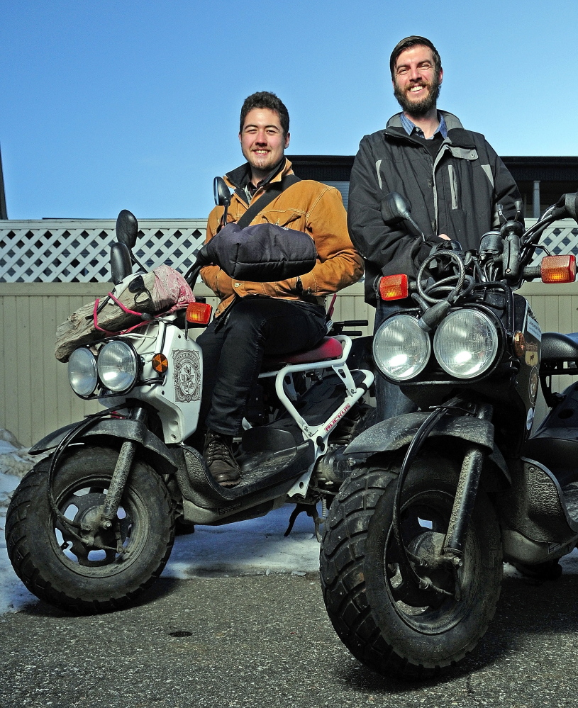 Myles Chung, left, and Dan Emery pose with their scooters Thursday in Augusta. They recently returned from a trip around the lower 48 states.