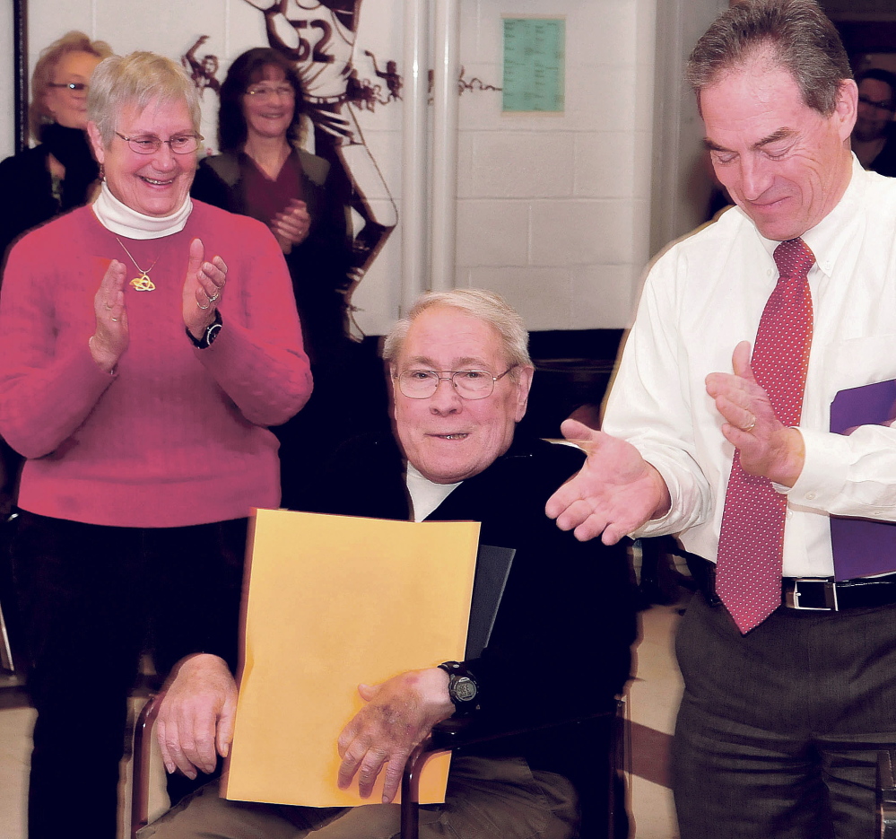 Staff photo by David Leaming
Retiring Waterville School Board member and chairman Lee Cabana was the center of attention as he was honored Monday at a Board of Education open house for more than 50 years working on behalf of Waterville schools. Applauding Cabana are his wife, Judy, and City Manager Mike Roy.