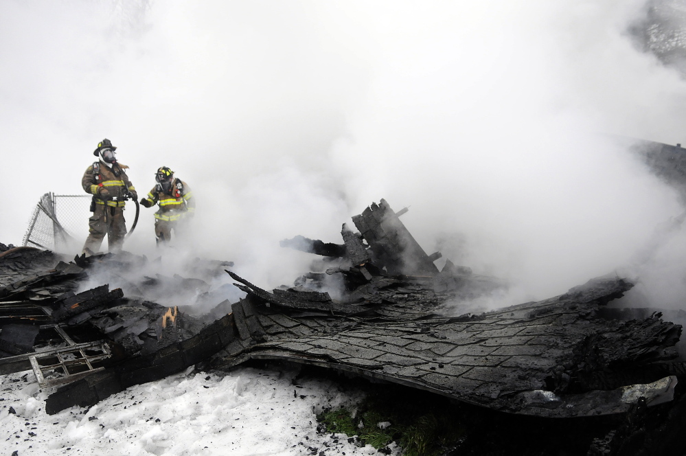 Firefighters search for hot spots Tuesday inside a South Gardiner barn that collapsed after catching fire in the afternoon. Owner Hope Olivencia said she lost some possessions belonging to her mother, who just relocated to South Gardiner, but she is grateful nobody was injured and her home was not damaged.