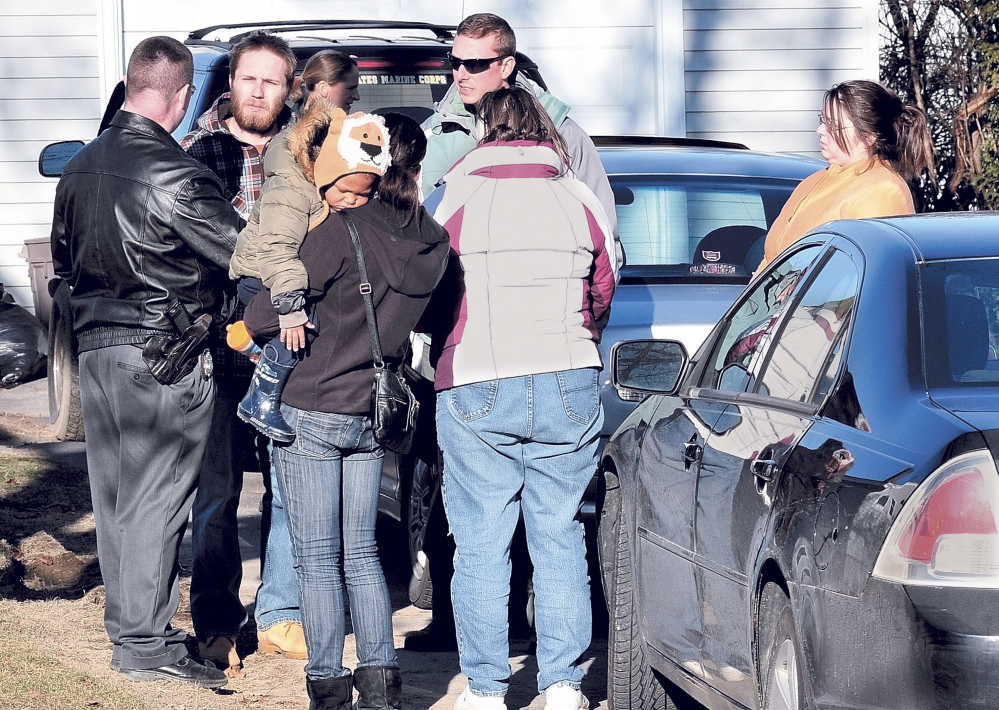 Maine State Police Detective Christopher Tupper, left, and Waterville Detective Lincoln Ryder, at right, question Justin DiPietro after he arrived at his home on Violette Ave. in Waterville on Sunday, Dec. 18, 2011, as an extensive search was underway at his home and the neighborhood for his 20-month-old daughter Ayla Reynolds.