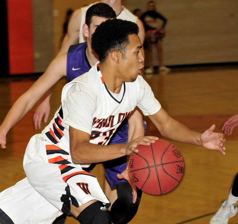Staff photo by David Leaming 
 Winslow's Earle Keanu drives toward the basket during a game against Waterville on Tuesday.