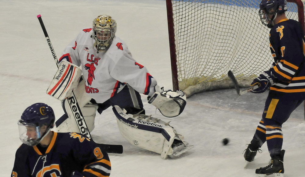 Lawrence/Skowhegan goalie Curtis Martin makes a save during a Class A crossover game against Cheverus on Wednesday night at Sukee Arena in Winslow.