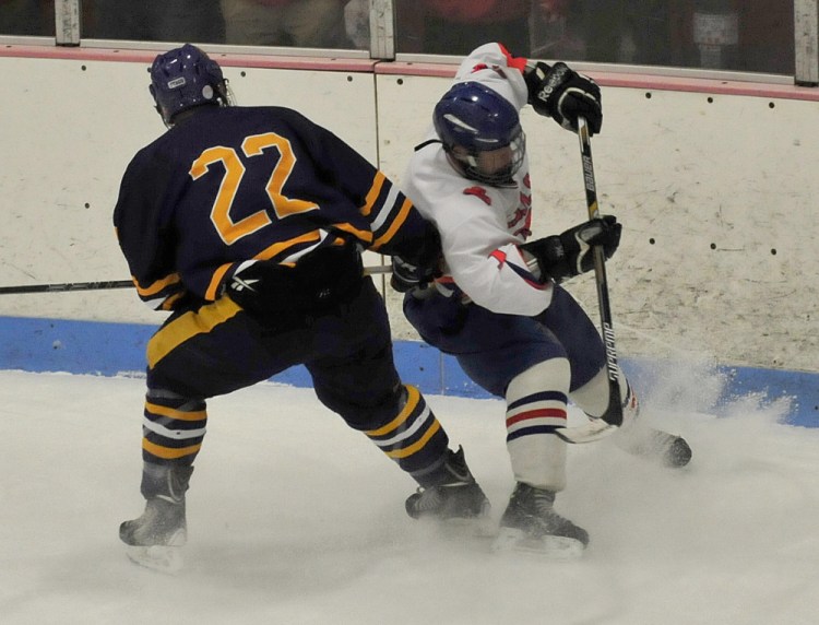 Cheverus senior Matt O’Leary (22) pressures Lawrence/Sowhegan’s Tyler Lewis during a Class A crossover game Wednesday night at Sukee Arena in Winslow.