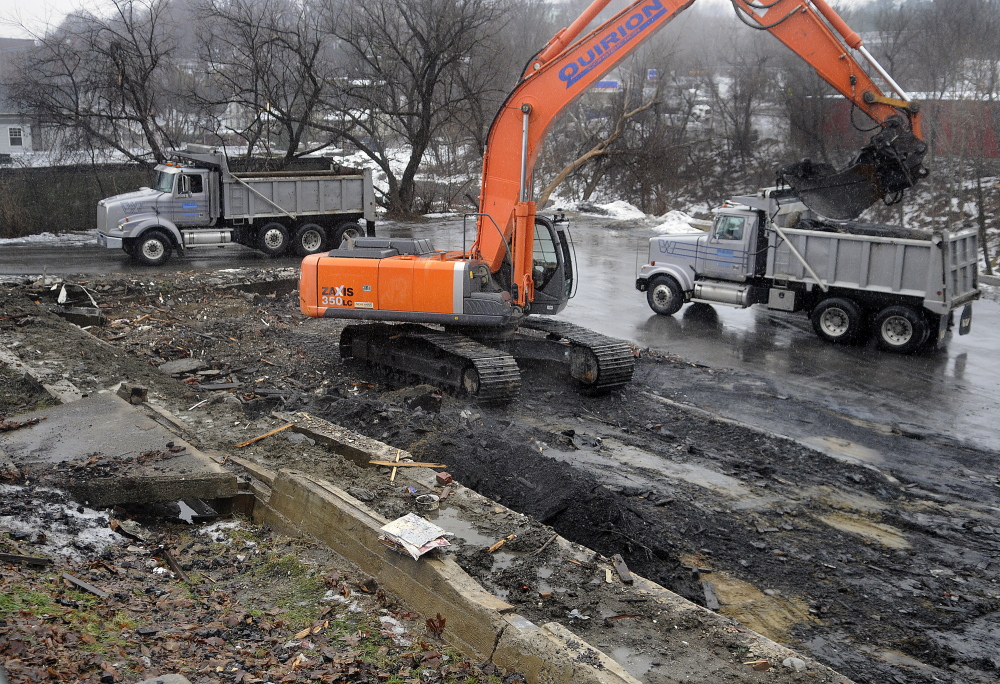 Crews remove debris Wednesday from the site of the apartment building that burned two weeks ago on Northern Avenue in Augusta.