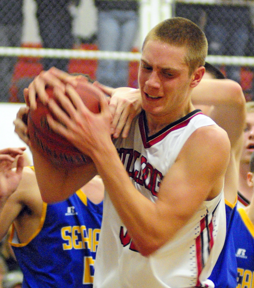 Hall-Dale’s Wesley LaPointe hangs onto a rebound against Boothbay during a Western C game Friday in the Penny Gym at Hall-Dale High School.