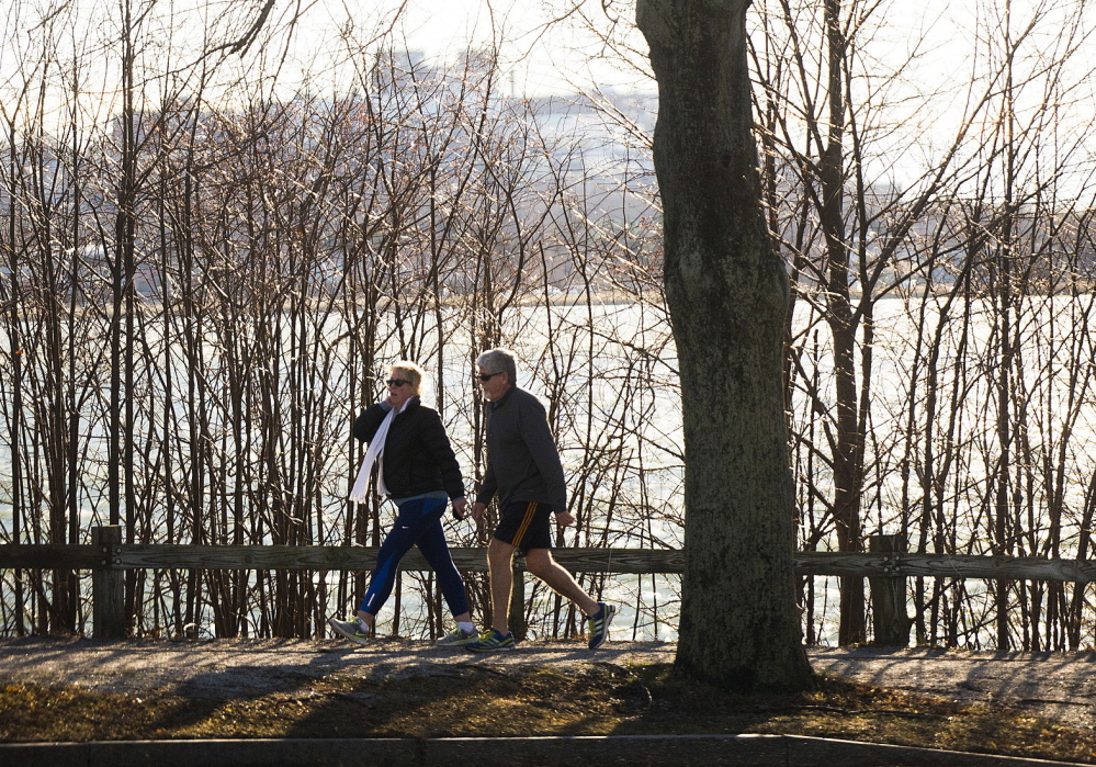 Two people take advantage of a nice warm Christmas with a stroll around Baxter Boulevard in Portland on Thursday. Christmas in Portland tied for the warmest Dec. 25 recorded, matching the previous high of 53 degrees last set in 1994.