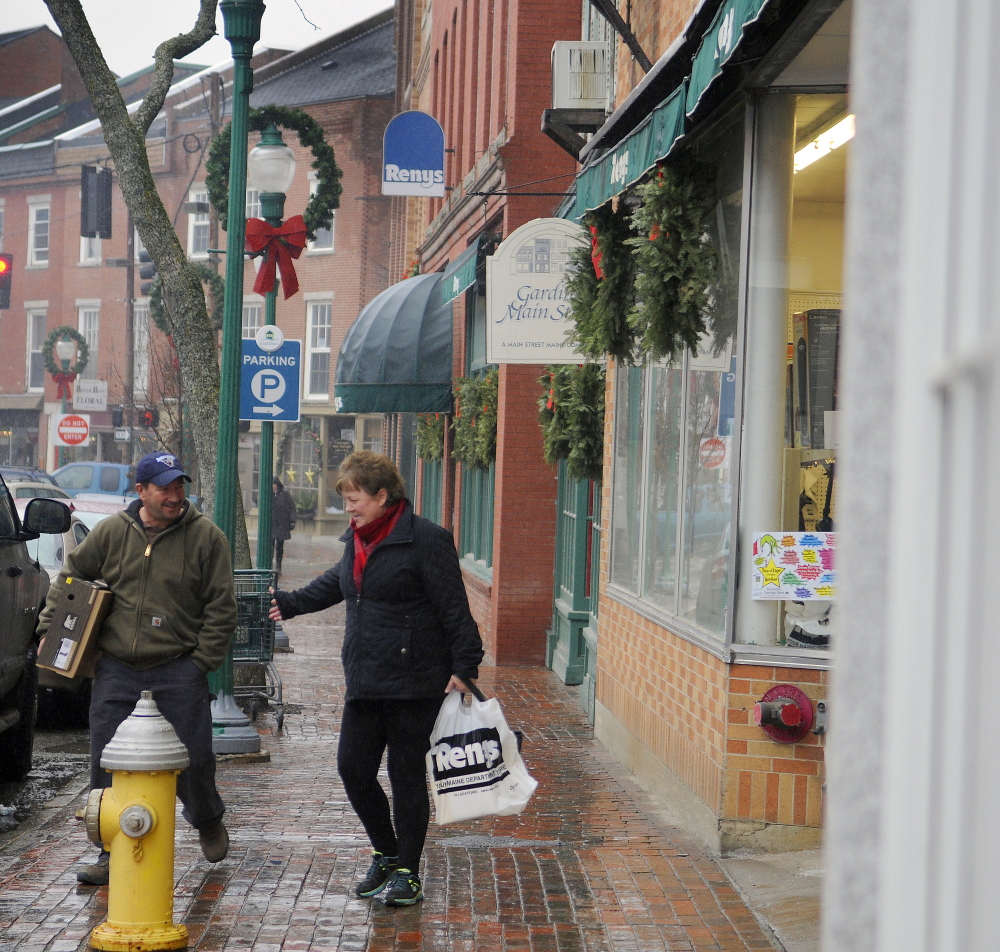 Shoppers exit Reny’s in downtown Gardiner on Wednesday, a week after city councilors voted not to fill the director of economic and community development position that has helped attract businesses to the city.