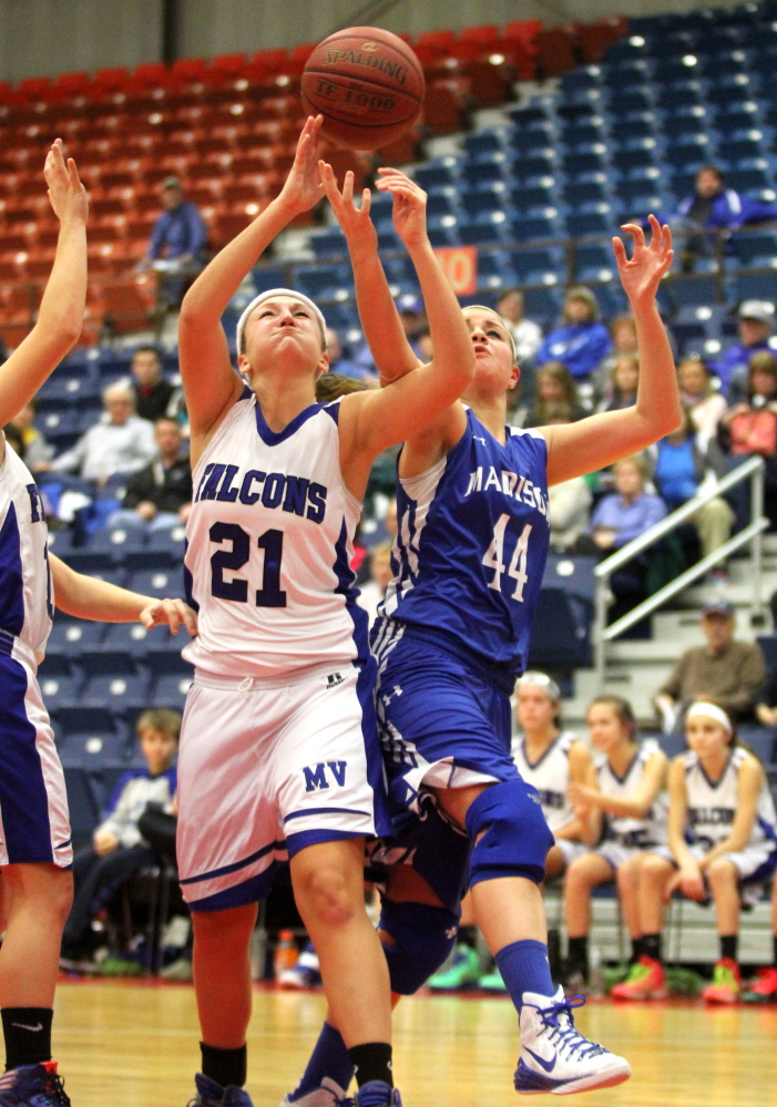 Madison Area Memorial High School’s Erin Whalen fights for a rebound with Mountain Valley High School’s Liza White during the first half of Saturday’s opening game at the annual Capital City Hoop Classic at the Augusta Civic Center. Madison lost 60-29.