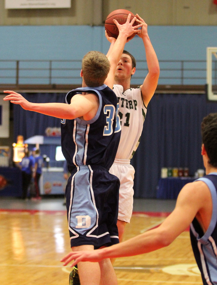 Winthrop High School’s Matt Sekerak keeps his eyes on the basket while shooting over Dirigo High School’s Clay Swett in the first half of Saturday’s game at the annual Capital City Hoop Classic at the Augusta Civic Center.