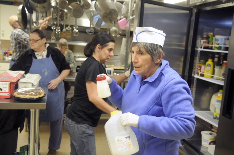 Kathy Walley replenishes cream at the Winthrop Hot Meals Kitchen during a meal at the St. Francis Parish Hall in Winthrop on Monday. The kitchen recently had to discontinue lunch on Fridays because of a shortage of volunteers. The group serves about 80 meals a day Monday through Thursday, but is in need of a Friday cook and other volunteers to help deliver meals and clean up.