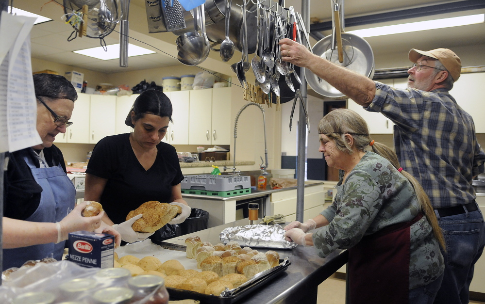 Volunteers at the Winthrop Hot Meals Kitchen prepare a meal in the kitchen at the St. Francis Parish Hall in Winthrop on Monday. The volunteers recently had to discontinue lunch on Fridays because of a shortage of volunteers. The group serves about 80 meals a day Monday through Thursday, but is in need of a Friday cook and other volunteers to help deliver meals and clean up. Monday’s crew includes, from left to right, Jeannette Latulippe, Jennifer McDougold, Beth Loon and Bob Letourneau.