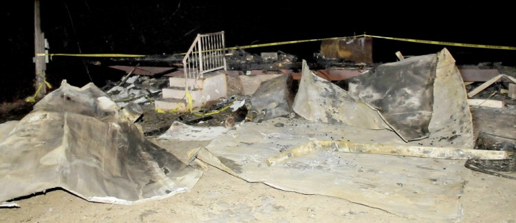 The flattened remains of a mobile home on Landry Place off the Crowell Road in Unity on Tuesday. The home was destroyed by fire last Sunday night.