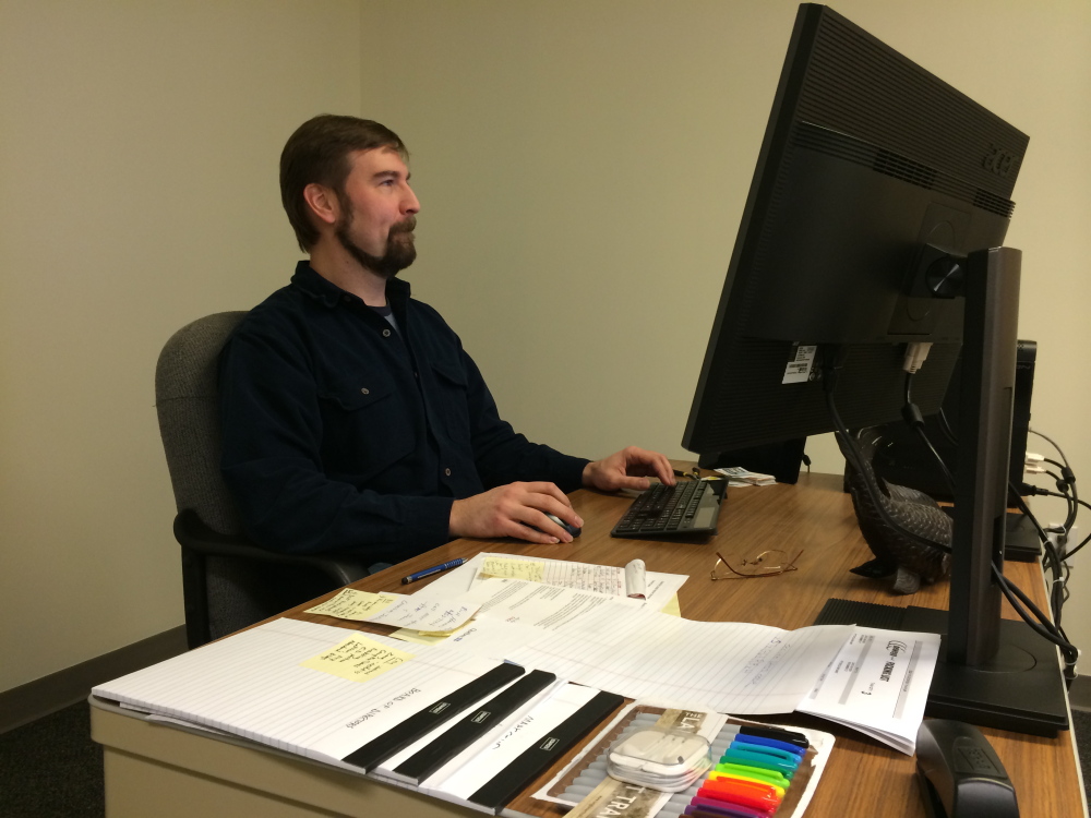 Nate Rudy, executive director of Waterville Creates!, settles in Wednesday at his new office in The Center on Main Street in Waterville. Rudy is the first director of the new nonprofit group and says he hopes to unite area arts and cultural groups in the new year.