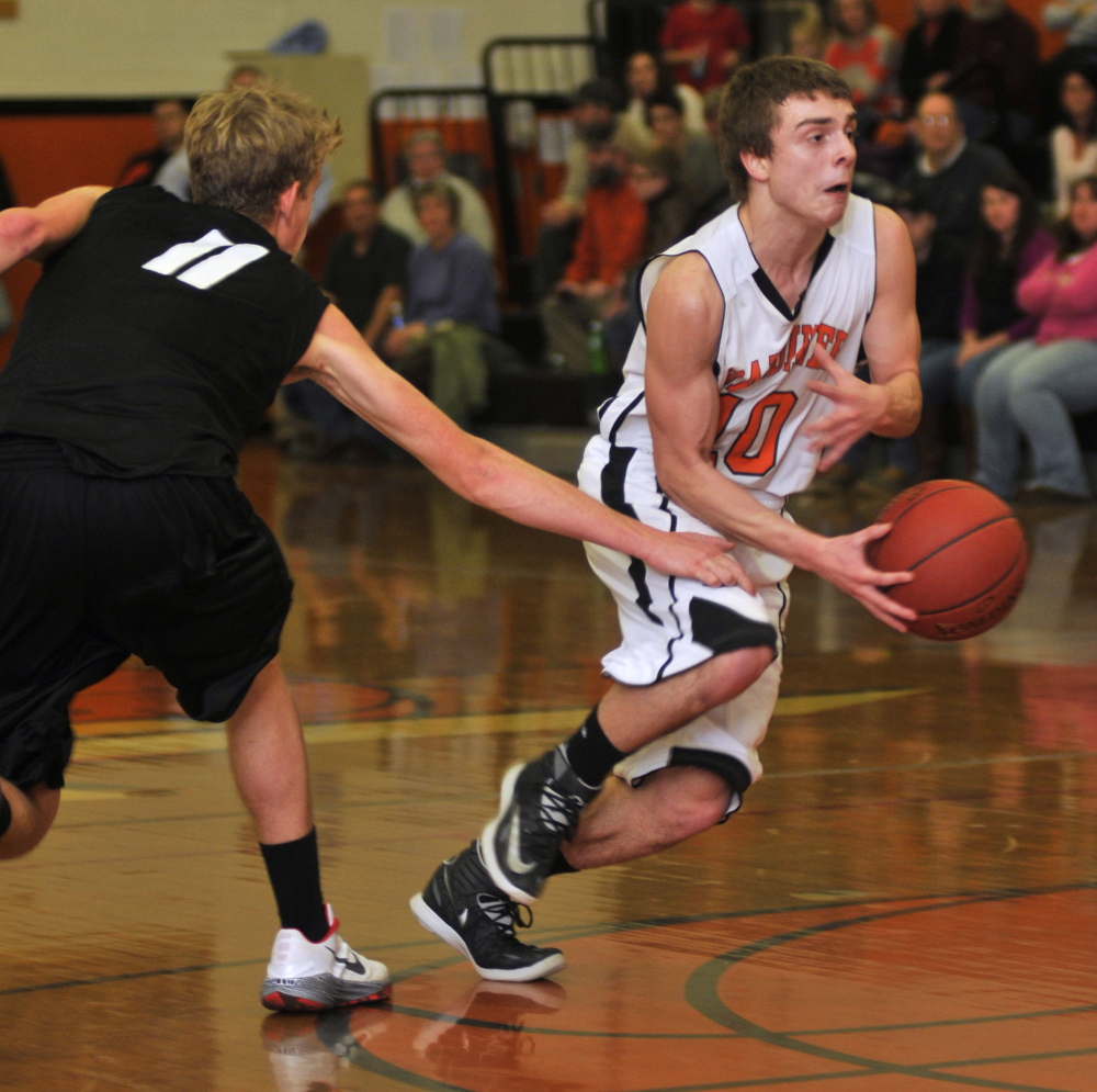 Lincoln Acadmey’s Devin Scherer, left, tries to stop Gardiner’s Brandon Douglas during a game Friday in the James A. Bragoli Memorial Gym at Gardiner Area High School. Gardiner won 66-43.