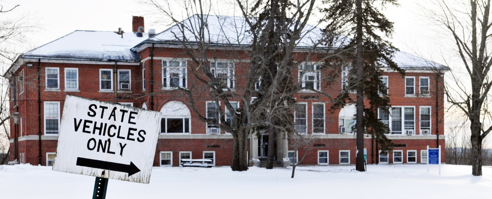 There were signs for the Department of Administrative and Financial Services and Department of Marine Resources in front of a building in the Stevens School complex in Hallowell on Tuesday. The city is mulling what to do with the 64-acre complex after the state moves out this spring.