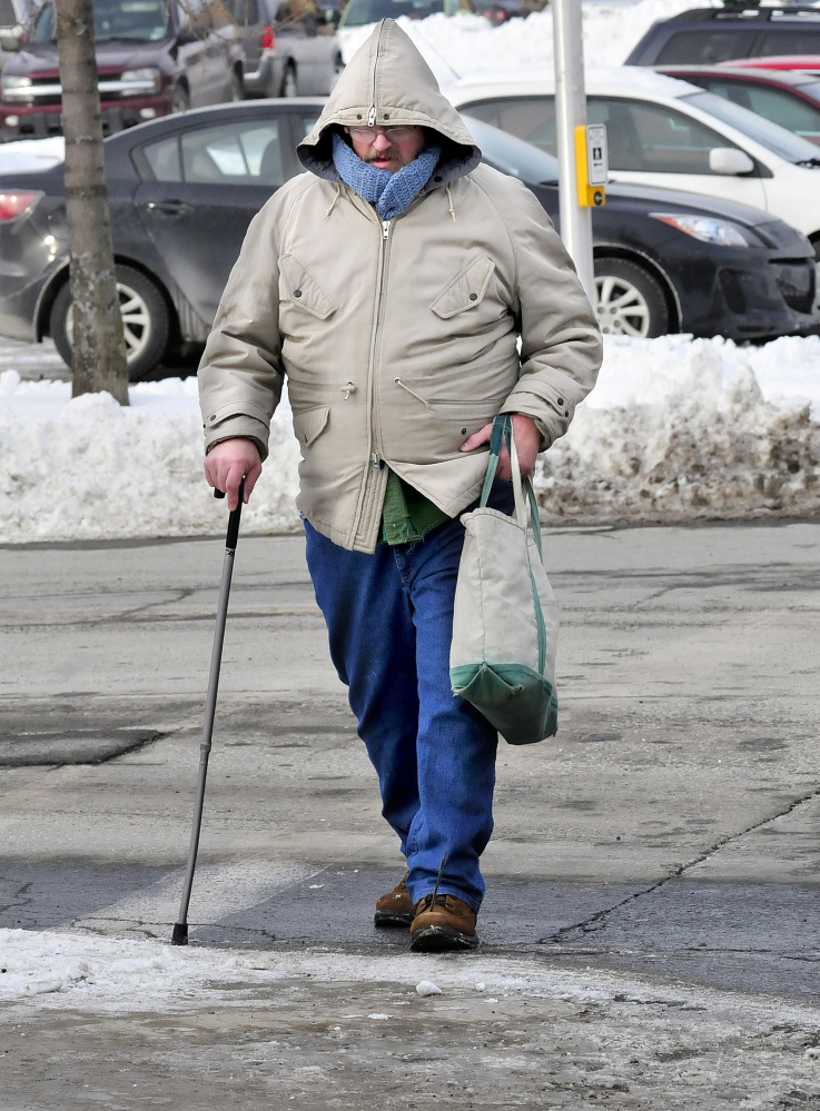 Staff photo by David Leaming
Dale Rollins bundled up to walk in the bitter cold in Waterville on Wednesday. “I’ve had enough of this cold,” Rollins said.