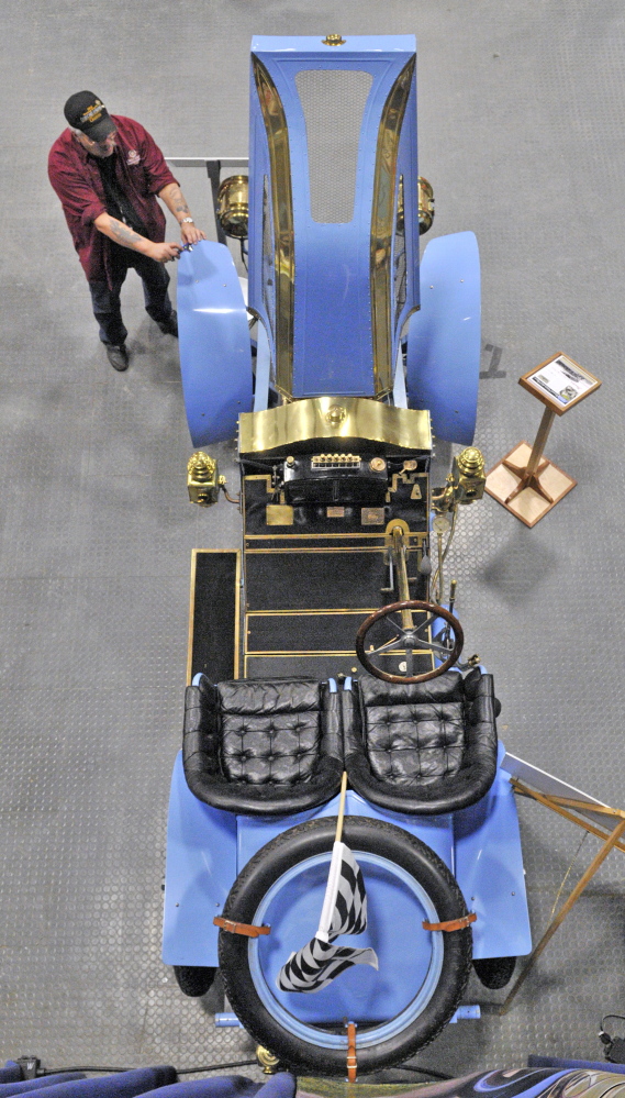 Warren Kincaid snaps a photo of a 1907 Renault Vanderbilt Racer in the Owls Head Transportation Museum display at the 27th annual Northeast Motorsports Expo and Trade Show on Friday at the Augusta Civic Center. Kincaid is the ground vehicle conservator at the museum and was telling visitors about the early race car.